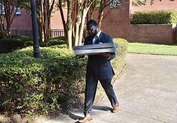 Archivist Tony Bounds transports Tougaloo archives for digitization.